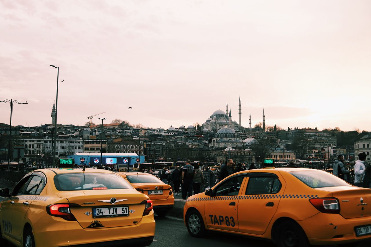 Crafting Captivating Headlines: Your awesome post title goes here Yellow taxis navigate busy Istanbul streets with iconic mosques in the background.